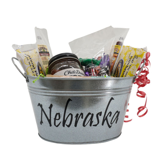 Metal bucket labeled 'Nebraska' filled with snacks and treats on a white background