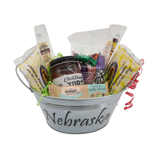 Gift basket with various items including a jar labeled 'Nebraska' on a white background