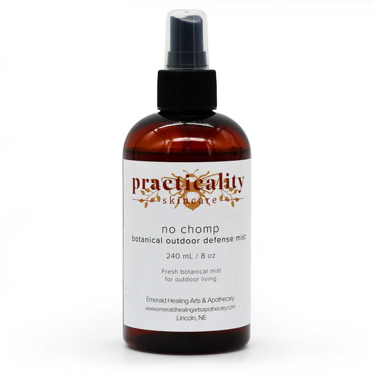 A 240 mL amber glass spray bottle of Practicity Skincare 'No Chomp' botanical outdoor defense mist, featuring a white label and black spray nozzle on a white background.