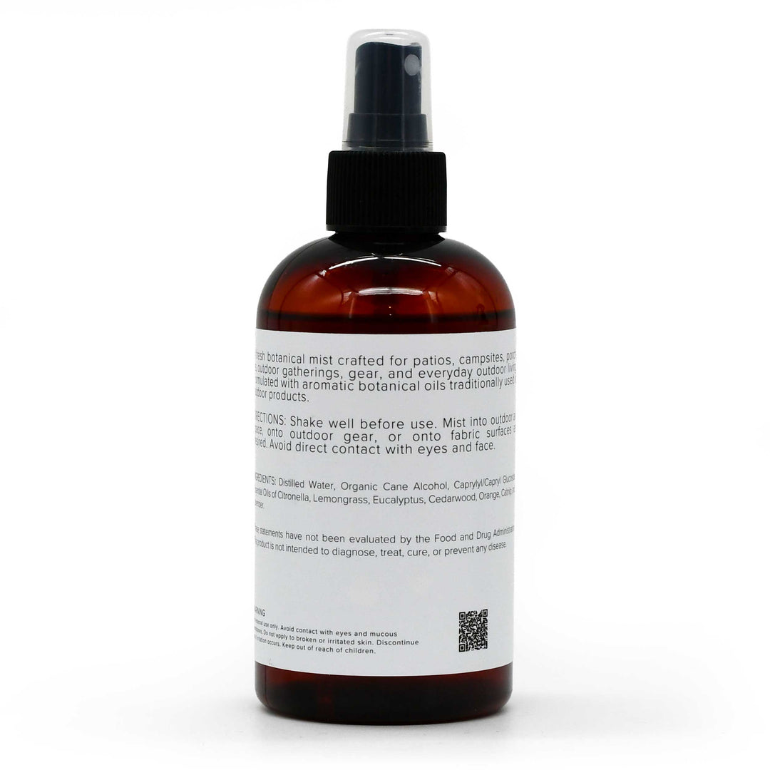 An amber glass spray bottle with a black pump dispenser and a white label, photographed against a clean white background.