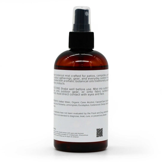 An amber glass spray bottle with a black pump dispenser and a white label, photographed against a clean white background.