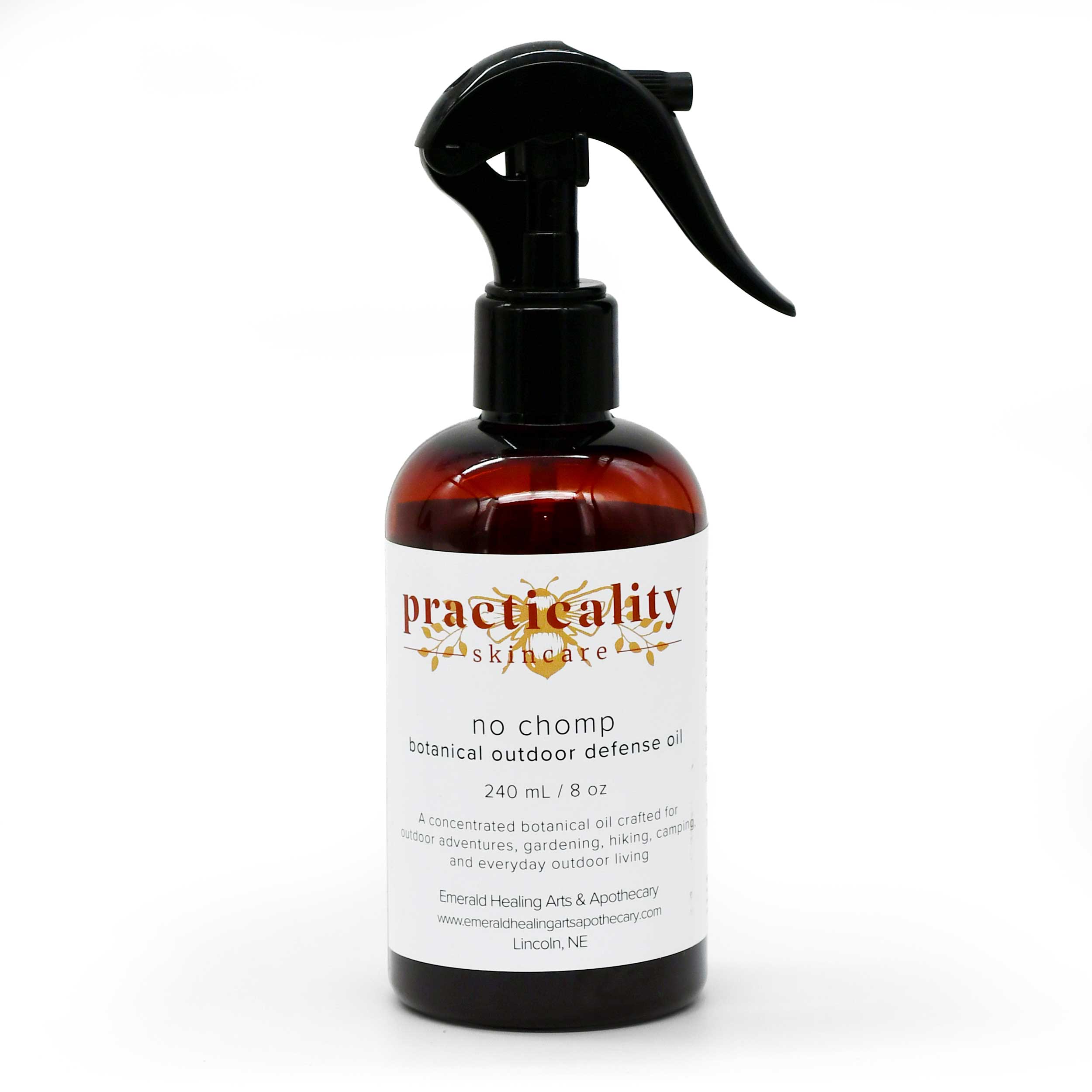 A 240 mL amber glass spray bottle of Practicality Skincare 'No Chomp' botanical outdoor defense oil, featuring a black trigger sprayer and a white label with gold and red text, set against a plain white background.