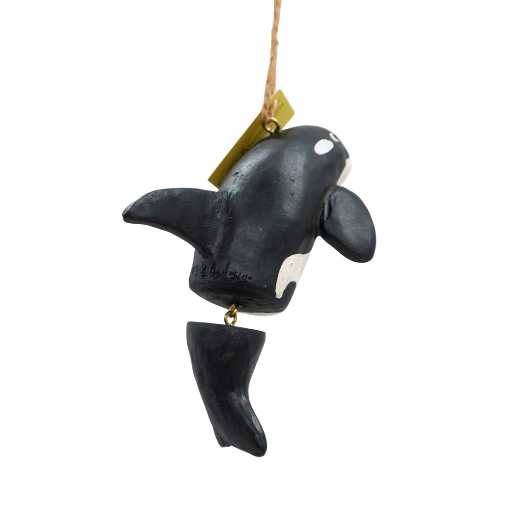 Orca whale ornament with a tag on a white background