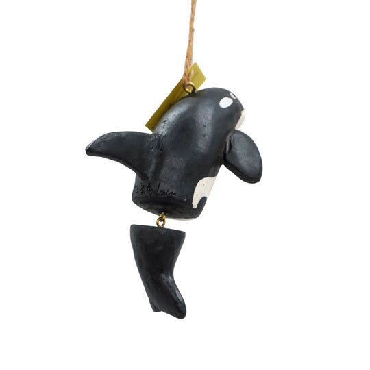 Orca whale ornament with a tag on a white background