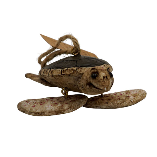 Decorative turtle ornament with a rope on a white background