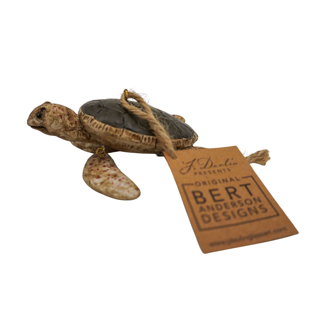 Tortoise figurine with a 'Bert Anderson Designs' tag on a white background