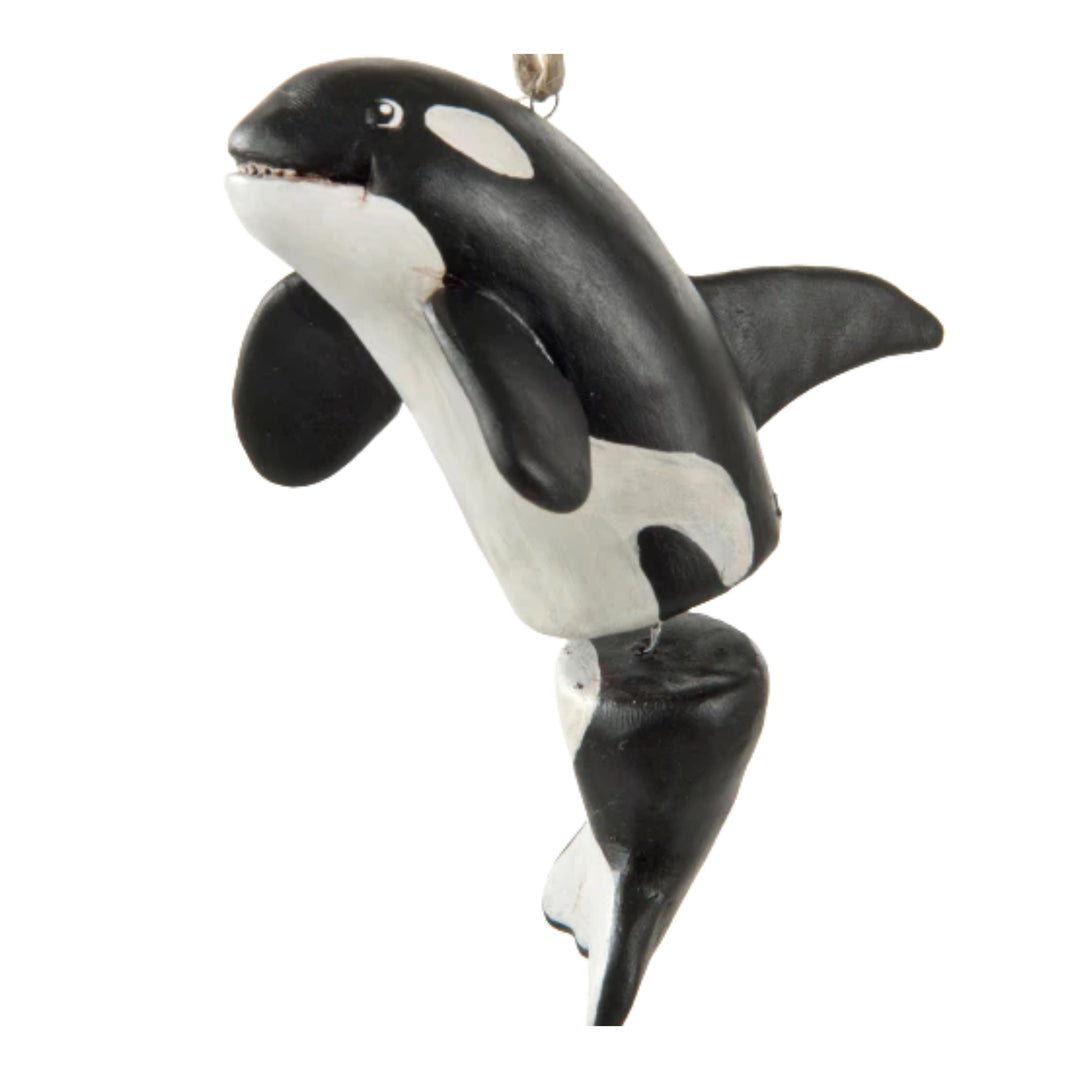 Black and white orca whale ornament on a white background