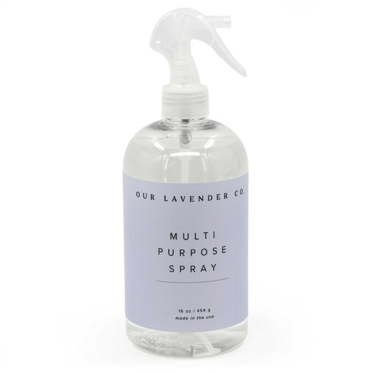 Clear spray bottle with lavender label on a white background