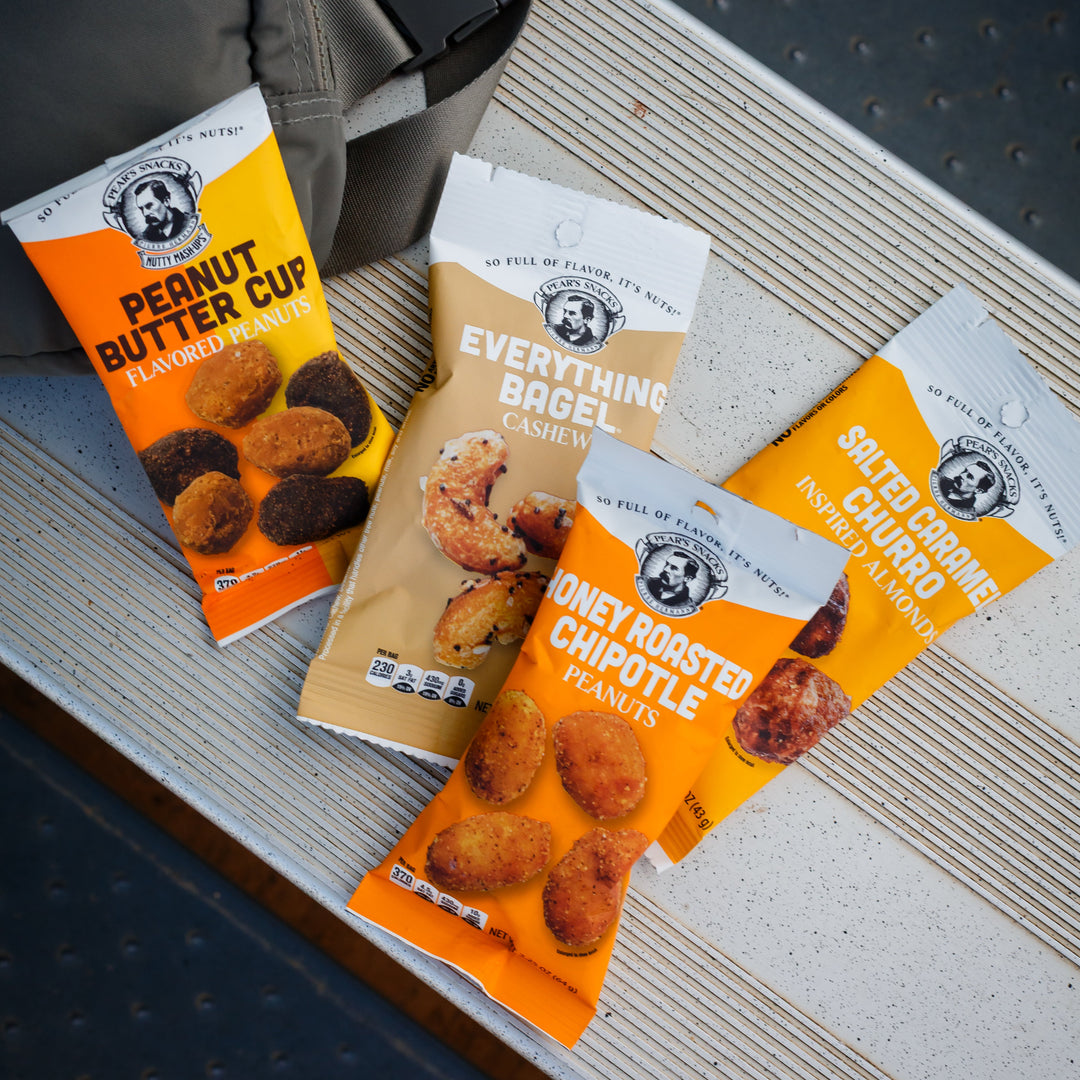 Three snack packages on a textured surface with a blurred background