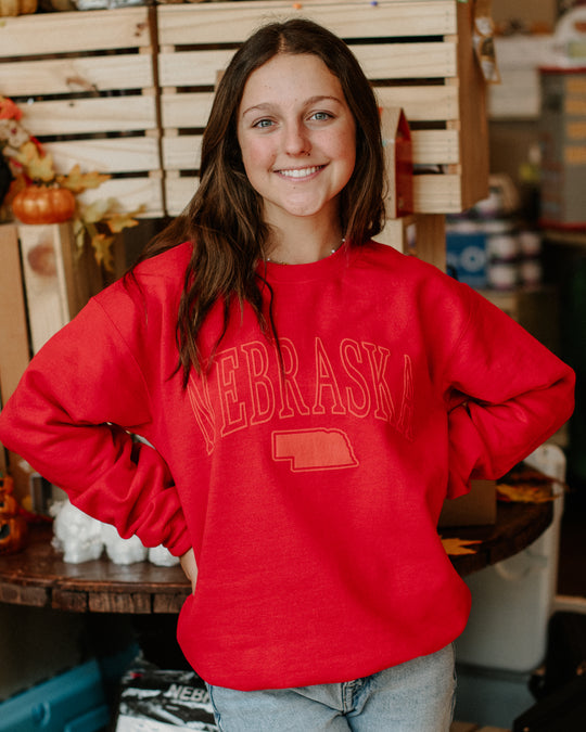 Red Nebraska Crewneck, Model is wearing size small