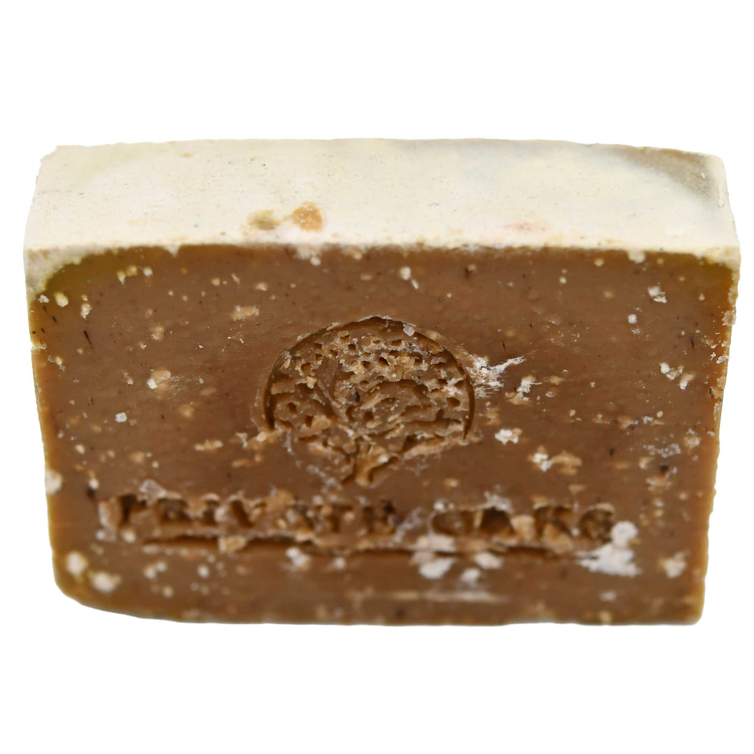 Bar of chocolate soap with a tree logo on a white background