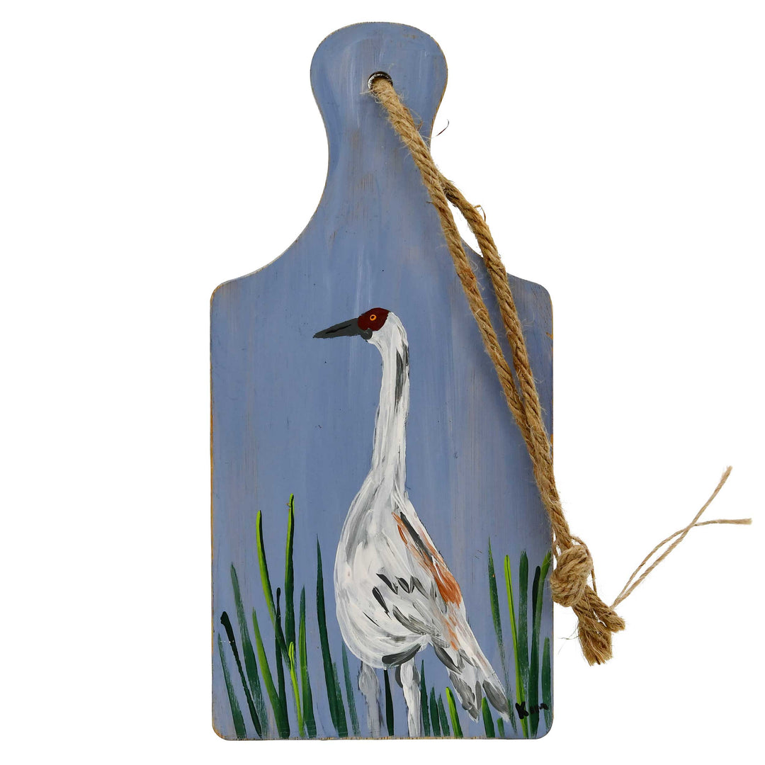 Decorative paddle with a painted crane on a blue background
