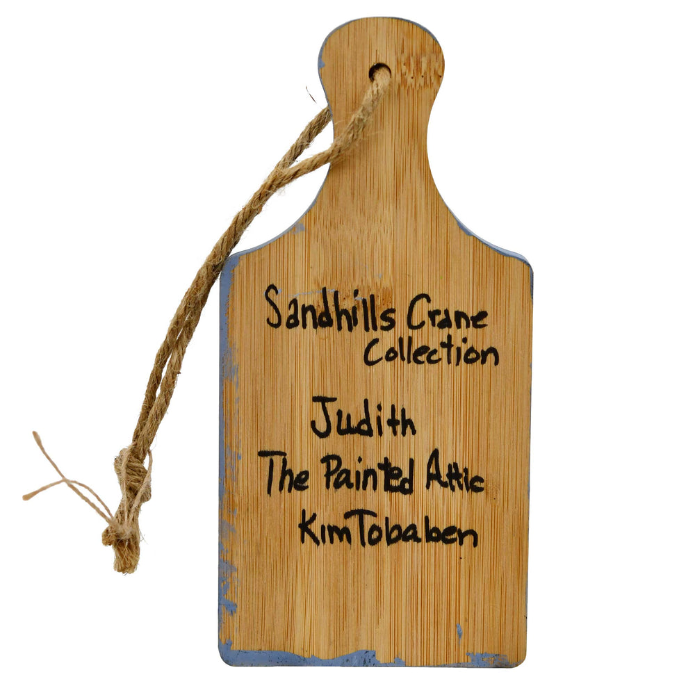 Wooden plaque with engraved text on a white background