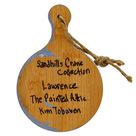 Wooden ornament with 'Sandhills Crane Collection' text and 'The Painted Attic' branding on a white background.
