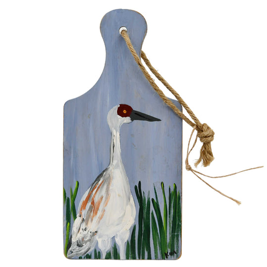 Decorative paddle with a painted bird design on a white background