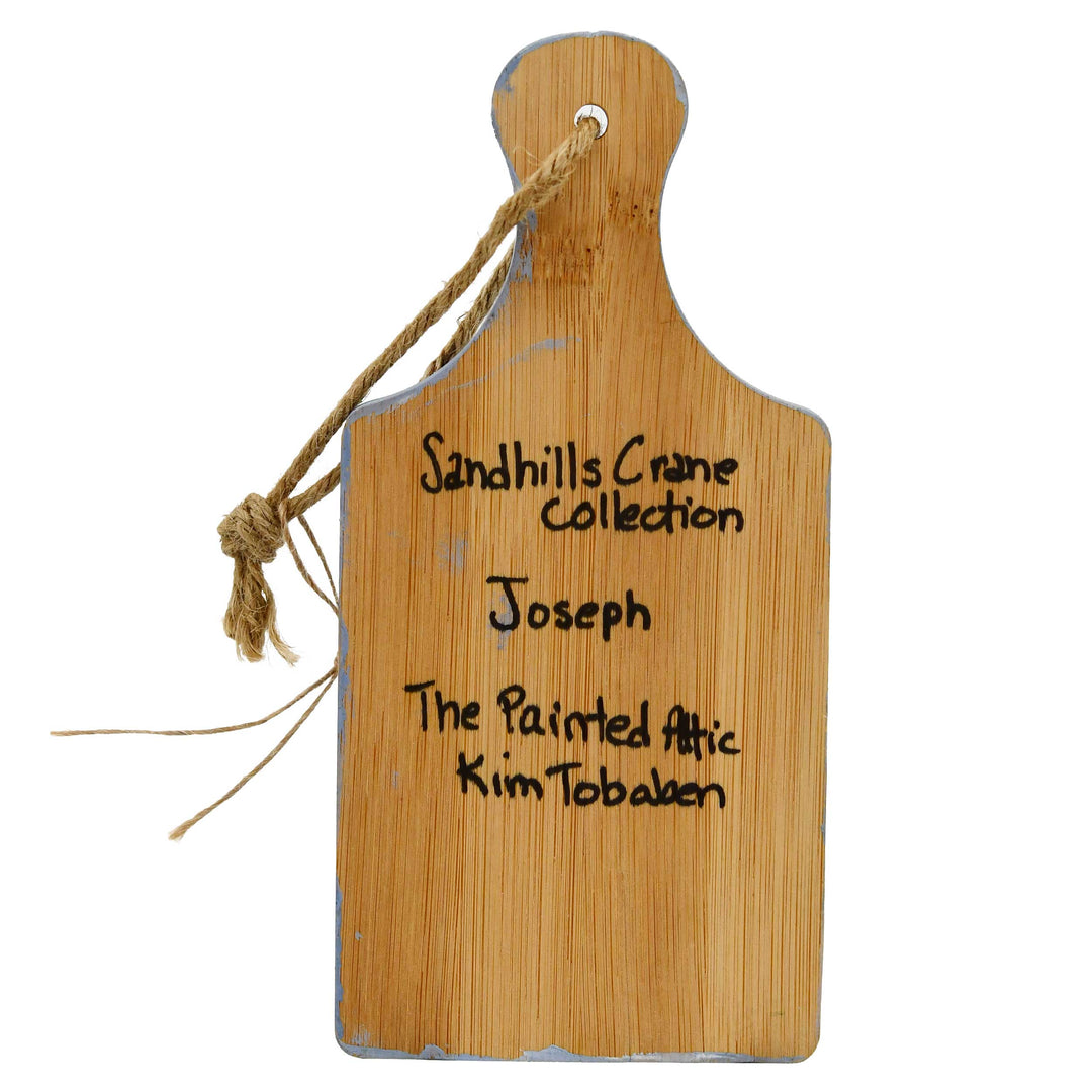 Wooden cutting board with engraved text on a white background
