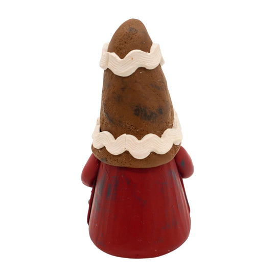 Gnome figurine with a gingerbread hat and cookie on a white background