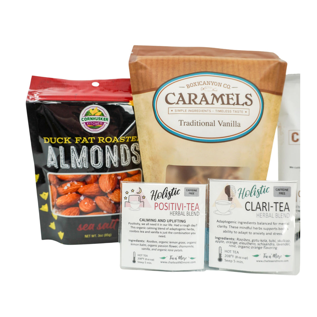 Packaging of duck fat roasted almonds, caramels, and tea boxes on a white background