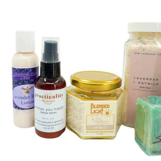 Collection of skincare and wellness products including lotion, spray, jar, and soap on a white background.