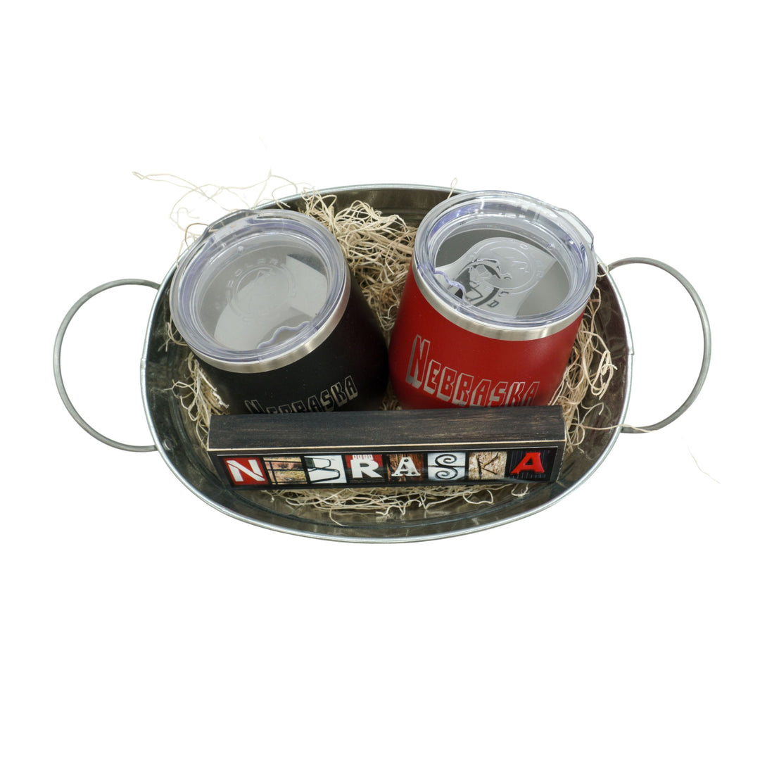 Two insulated tumblers with Nebraska branding on a metal tray.