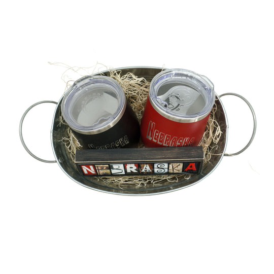Two insulated tumblers with Nebraska branding on a metal tray.