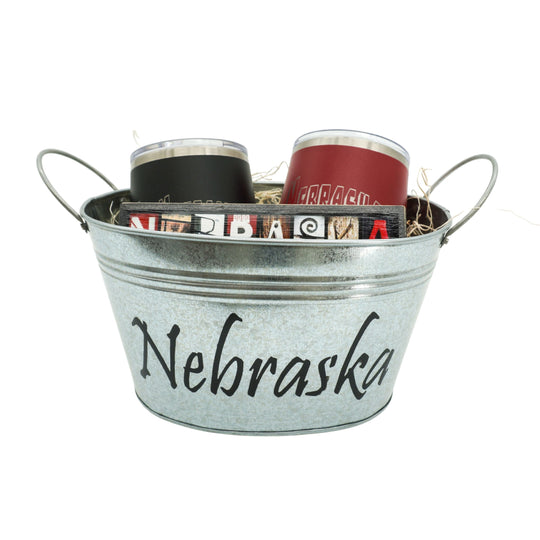 Metal bucket with 'Nebraska' text containing tumblers on a white background