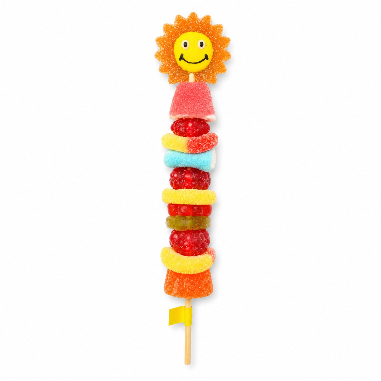Smiling sun candy kabob topped with a smiling sun shaped gummy and stacked with assorted gummy candies on a wooden skewer, isolated on a white background.