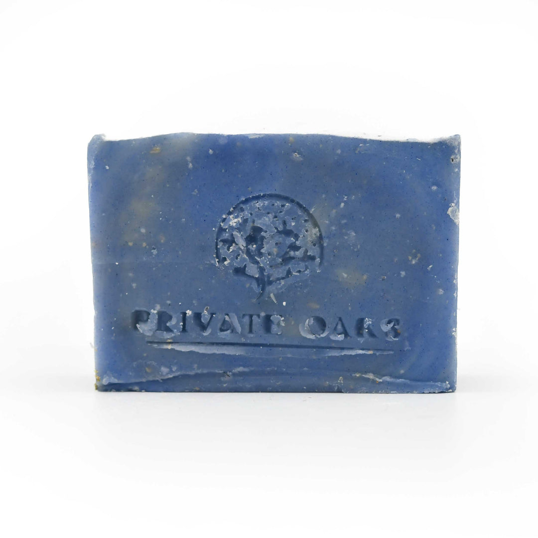 Blue bar of soap with 'Private Oaks' branding on a white background