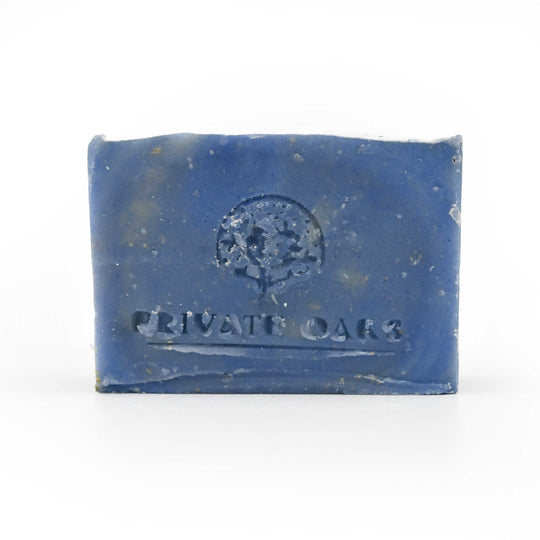 Blue bar of soap with 'Private Oaks' branding on a white background