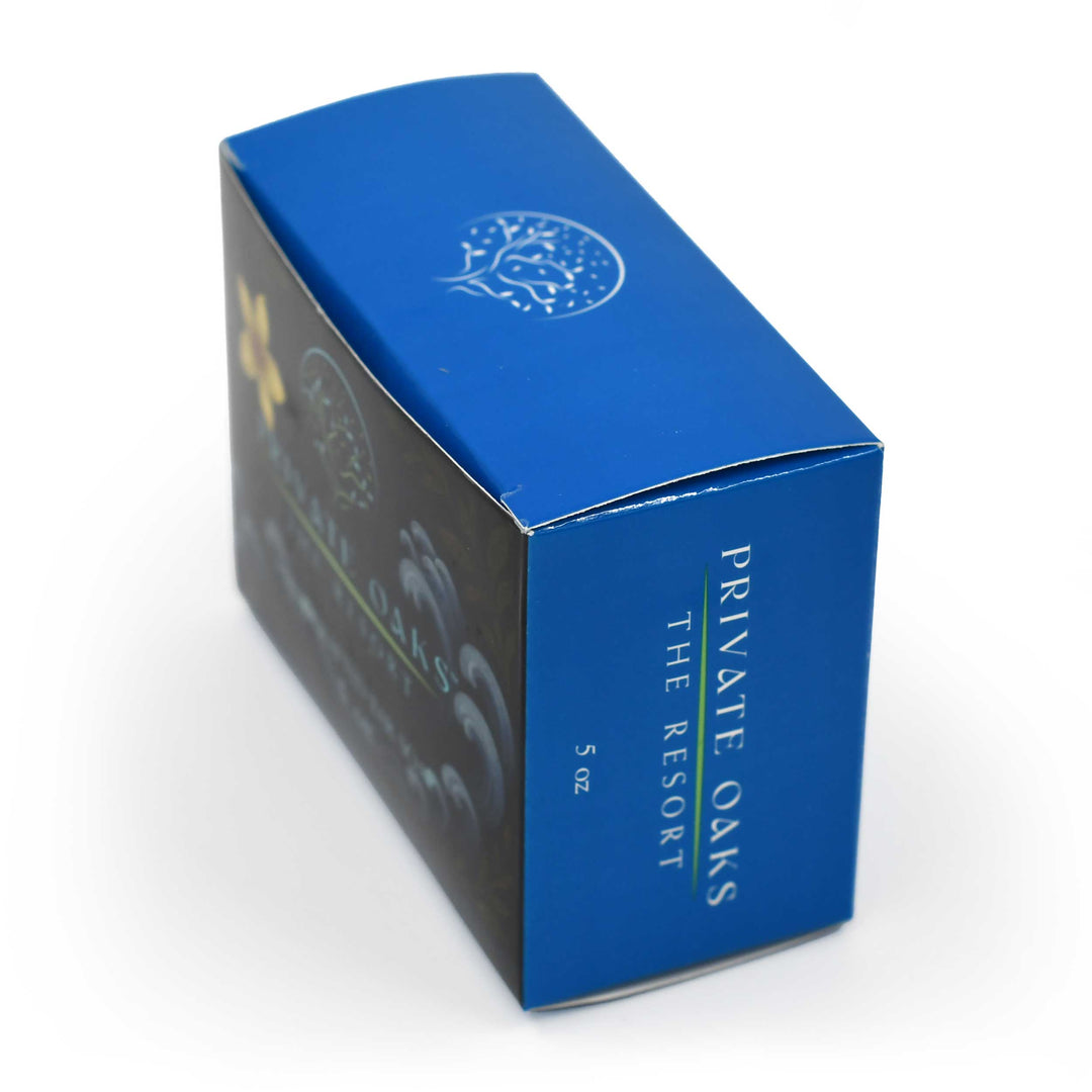 Blue and black packaging box for 'Private Oaks The Resort' on a white background