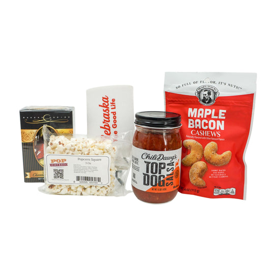Assorted snack items including popcorn, salsa and cashews on a white background
