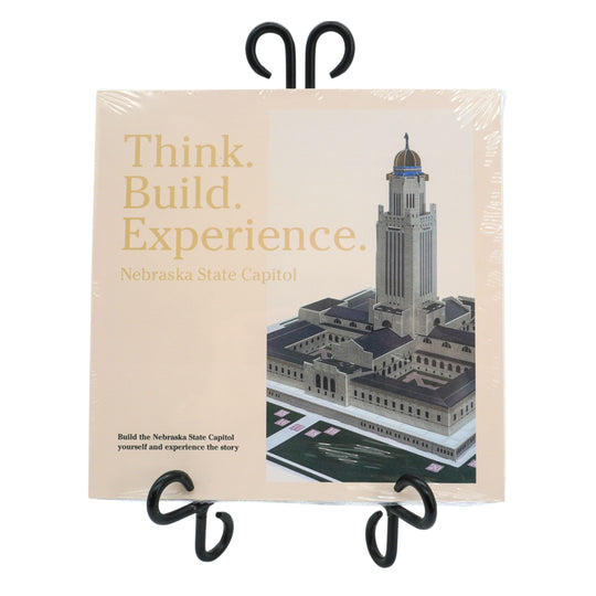 Nebraska State Capitol model kit packaging with text 'Think. Build. Experience.' on a white background.