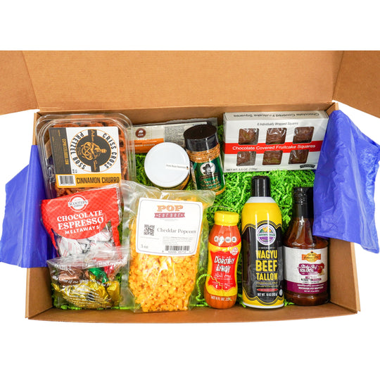 Open cardboard box containing various Nebraska food items and products.