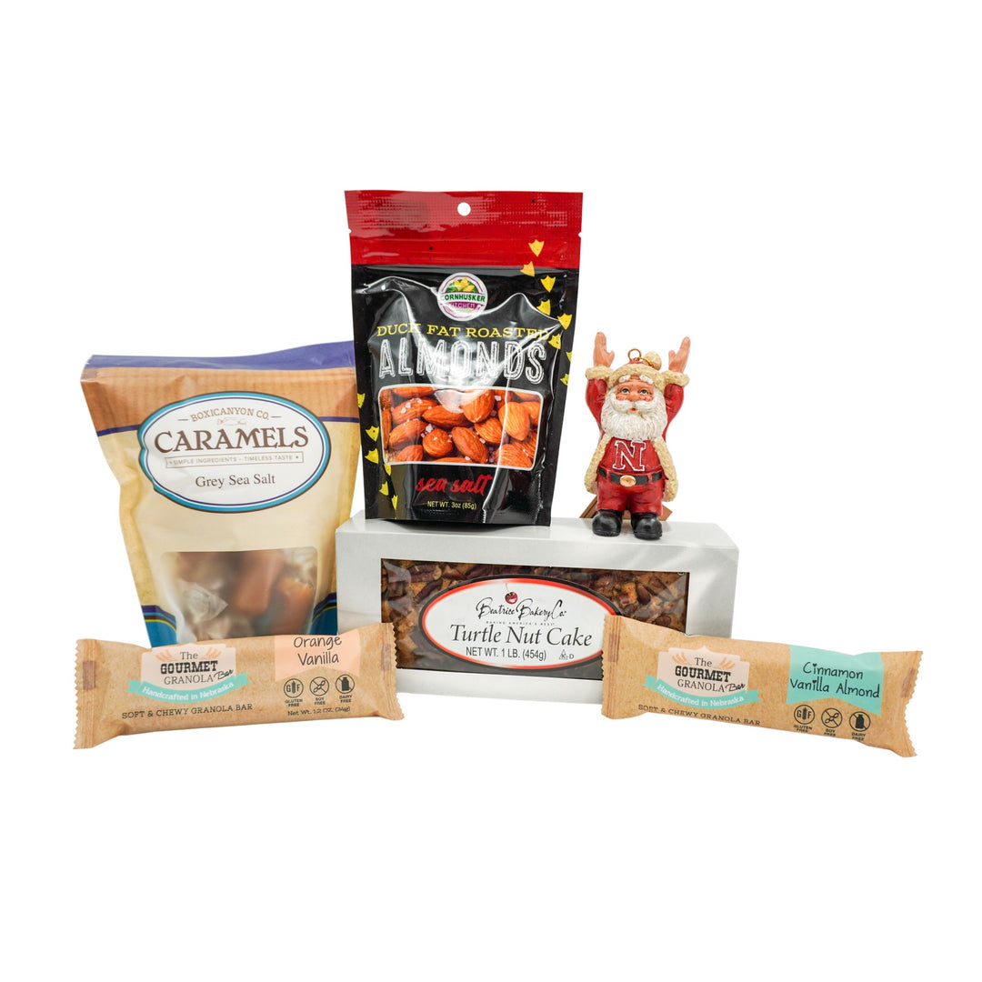 Assorted food items including caramels, nuts, and a nut cake on a white background