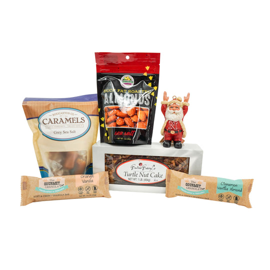 Assorted food items including caramels, nuts, and a nut cake on a white background