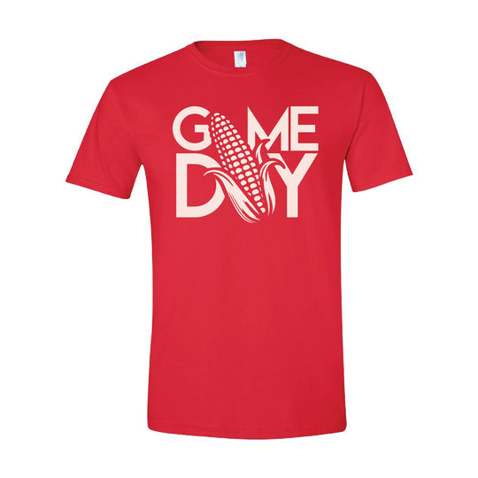 A red short-sleeve crewneck t-shirt with a white graphic on the chest that reads 'GAME DAY' with a corn cob illustration, shown on a plain white background.