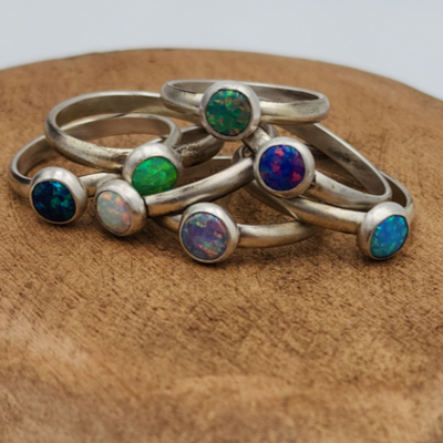 Sterling Silver Opal Rings Stacked on Top of Each other on wood