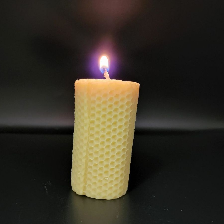 A Lit 6 oz. Bees Wax Candle