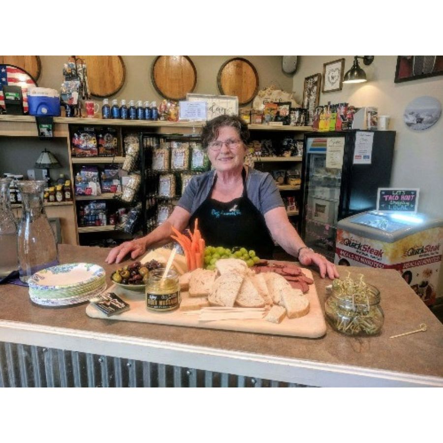 Betty, CEO Of Buzz Savories, standing next to her product.