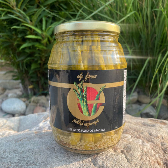 Outdoor picture of a jar of pickled asparagus.