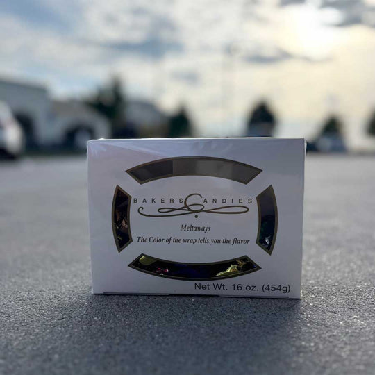 Bakers Candies packaging on a reflective surface with blurred background