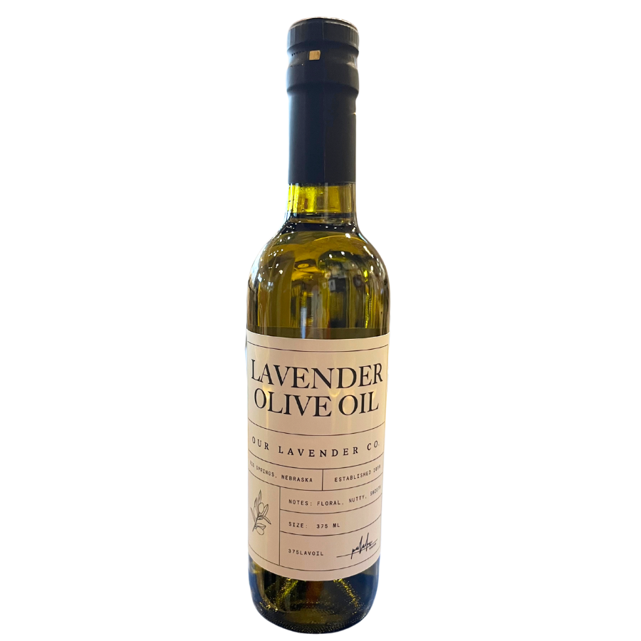 A glass bottle of Lavender Infused Olive Oil with a label that includes the brand name and the product name.