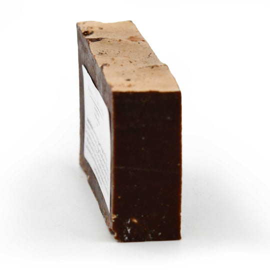 Rectangular block of soap with a lighter top on a white background