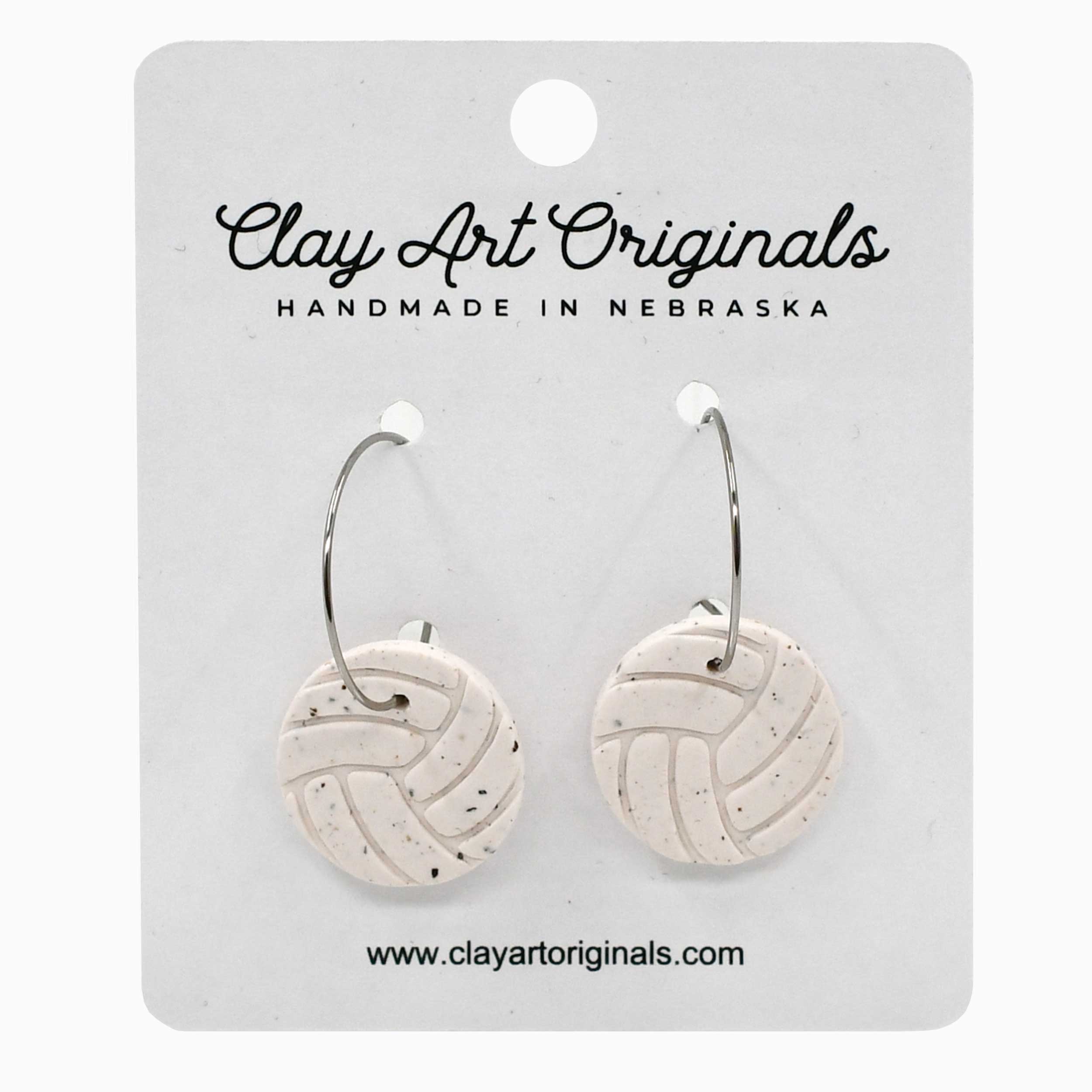 Pair of round earrings on a 'Clay Art Originals' card.