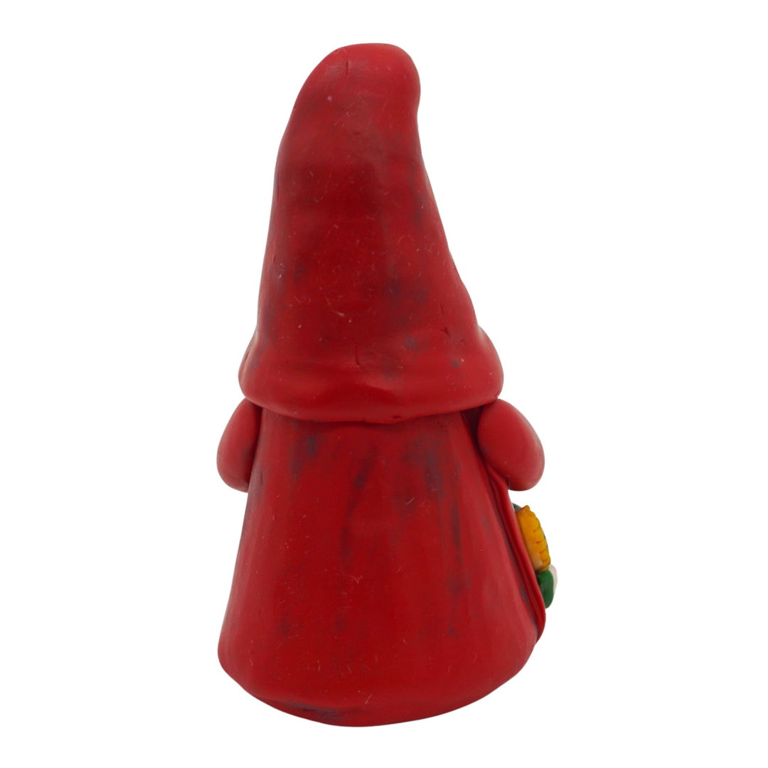 Back of a red gnome figurine with a white background