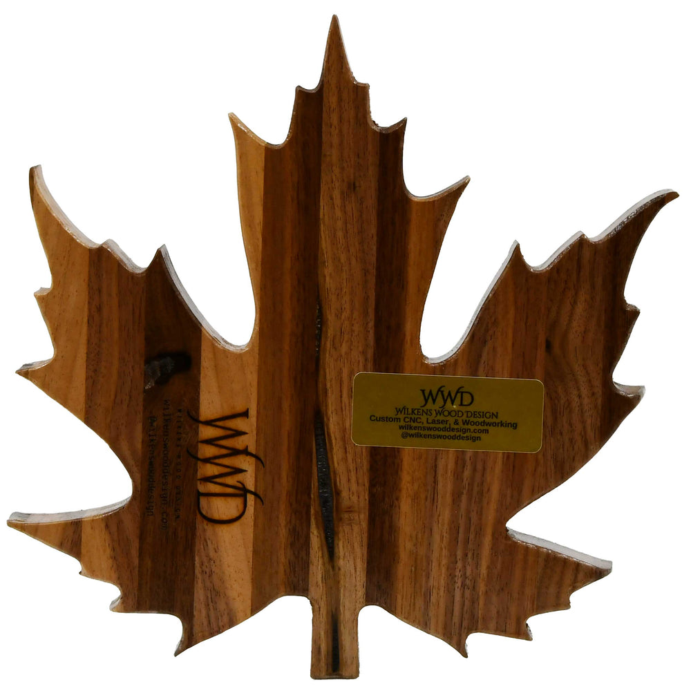 Wooden maple leaf-shaped object with 'WWD' branding on a white background