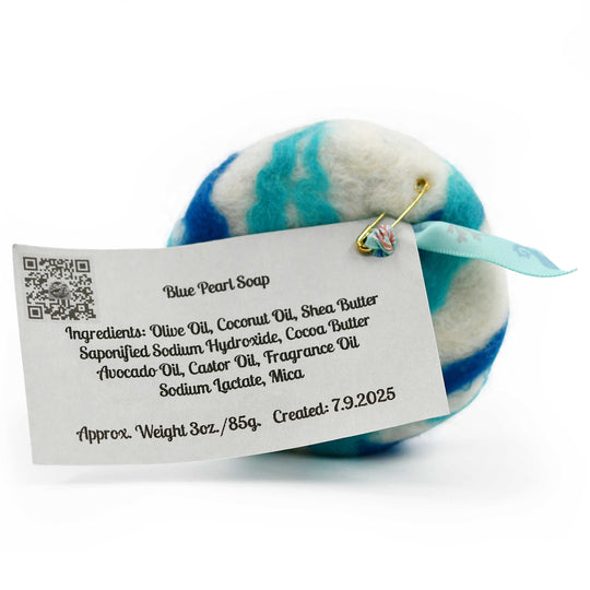 Blue and white striped felted soap with a label on a white background