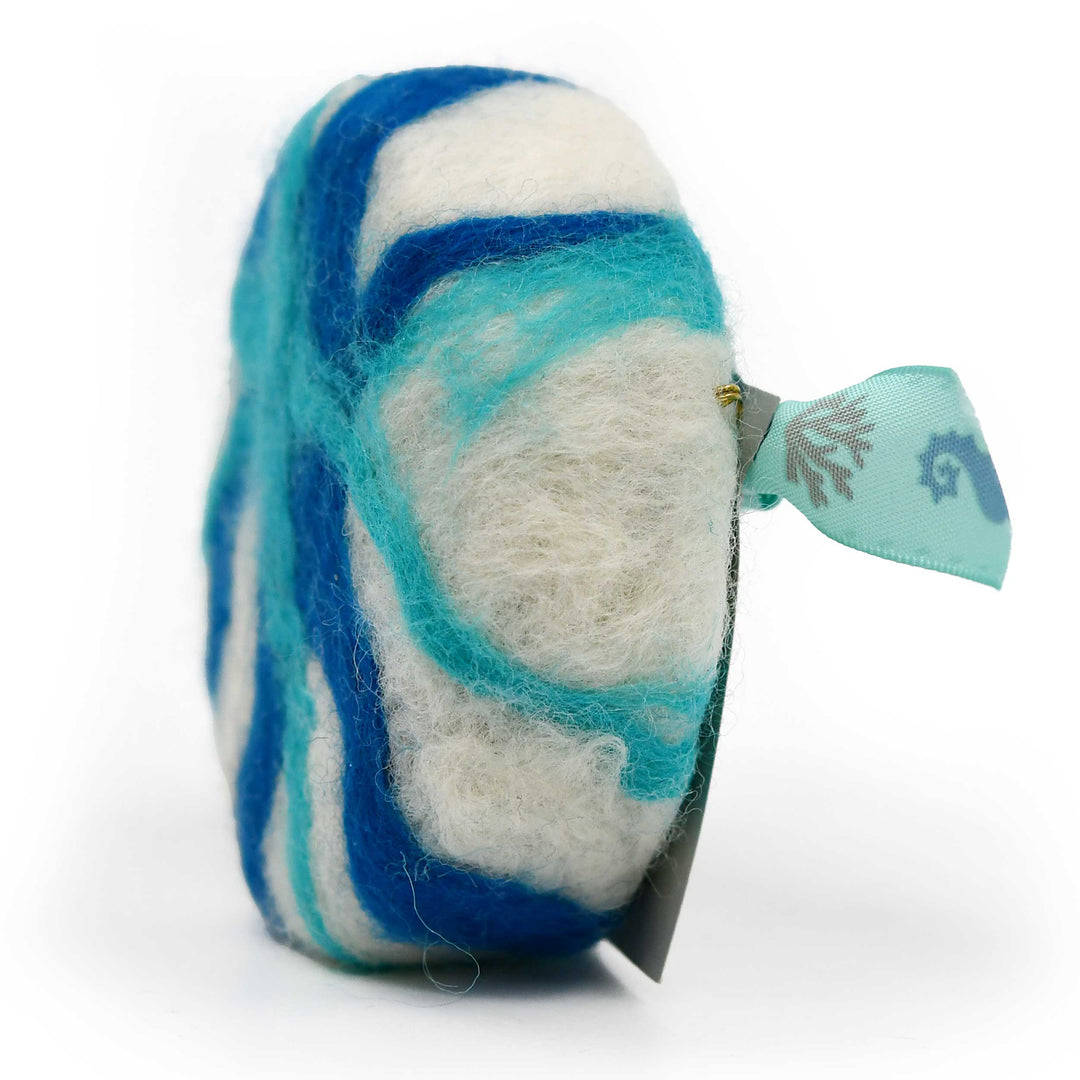 Felted soap with blue and white pattern on a white background