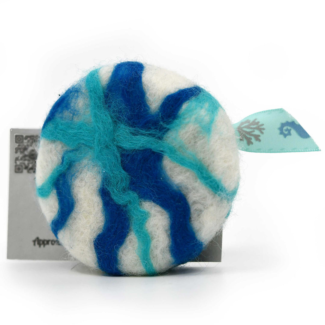 Blue and white felted soap with a tag on a white background