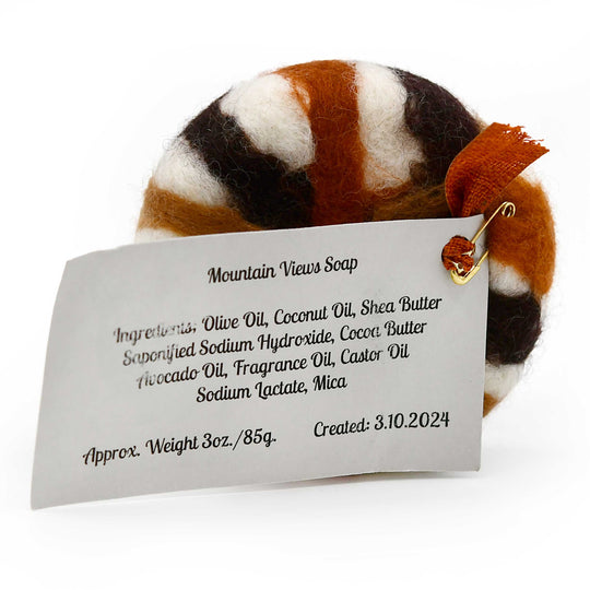 Soap with a label detailing ingredients and creation date on a white background